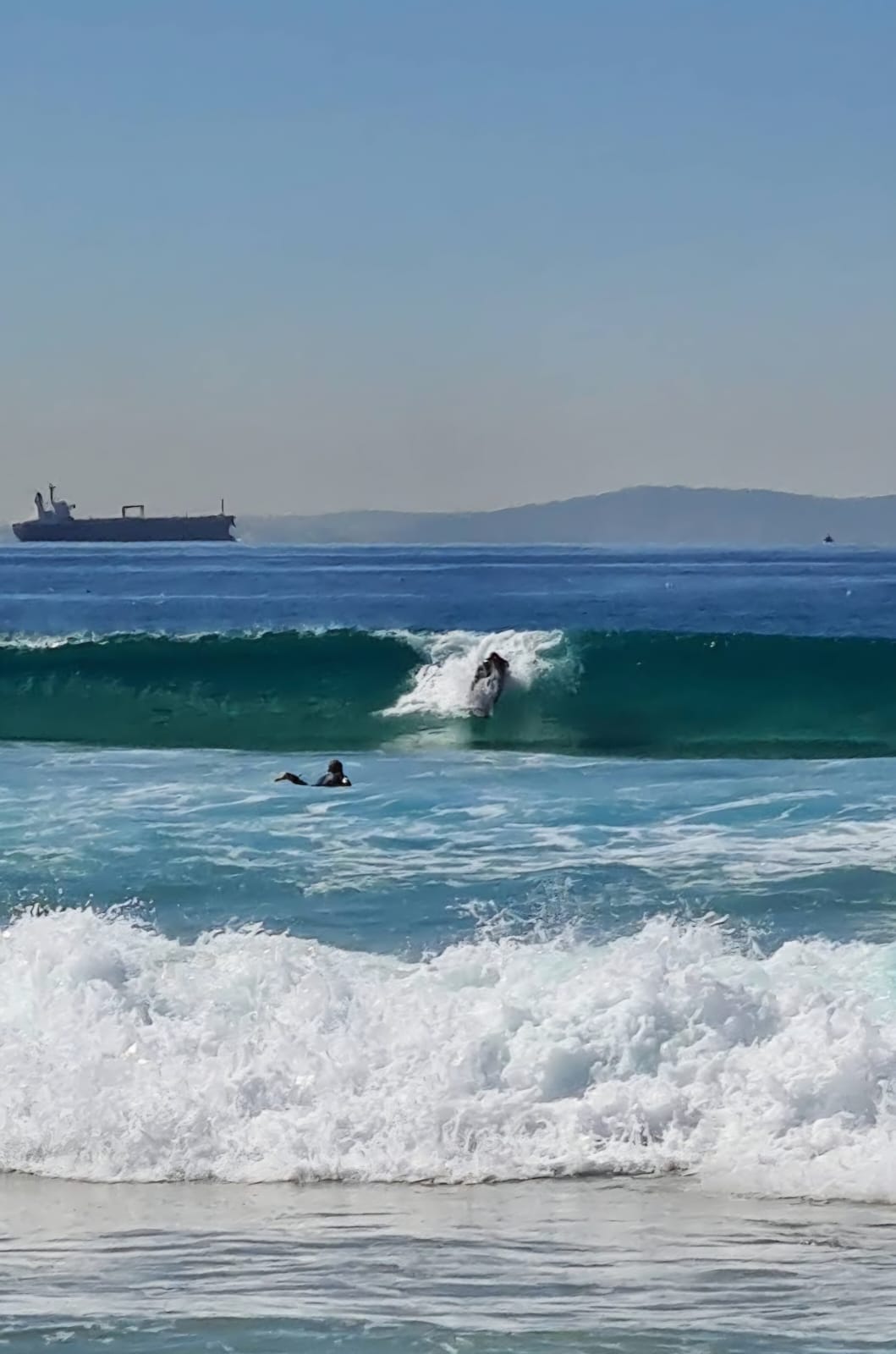 Surfer catching a wave at a Tarifa beach break near the townhouse